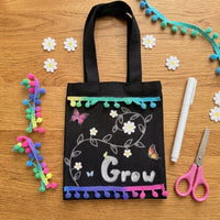 Finished Grow tote bag kit on a desk with scissors and pens