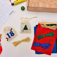 Crafting materials including yarn, bags, and a box on a white surface
