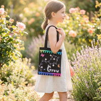 Girl in a garden with a hand-decorated Grow tote bag